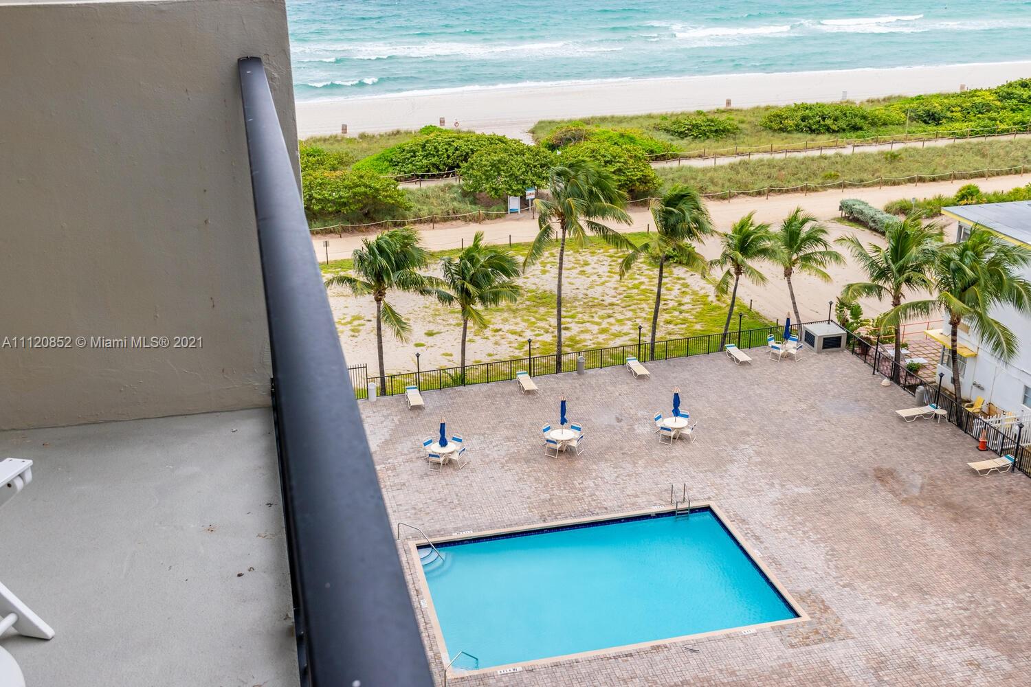 9273 Collins Avenue, Unit 801 Surfside, FL 33154 - Photo 21 of 47 a view of a room with a floor to ceiling window next to a yard