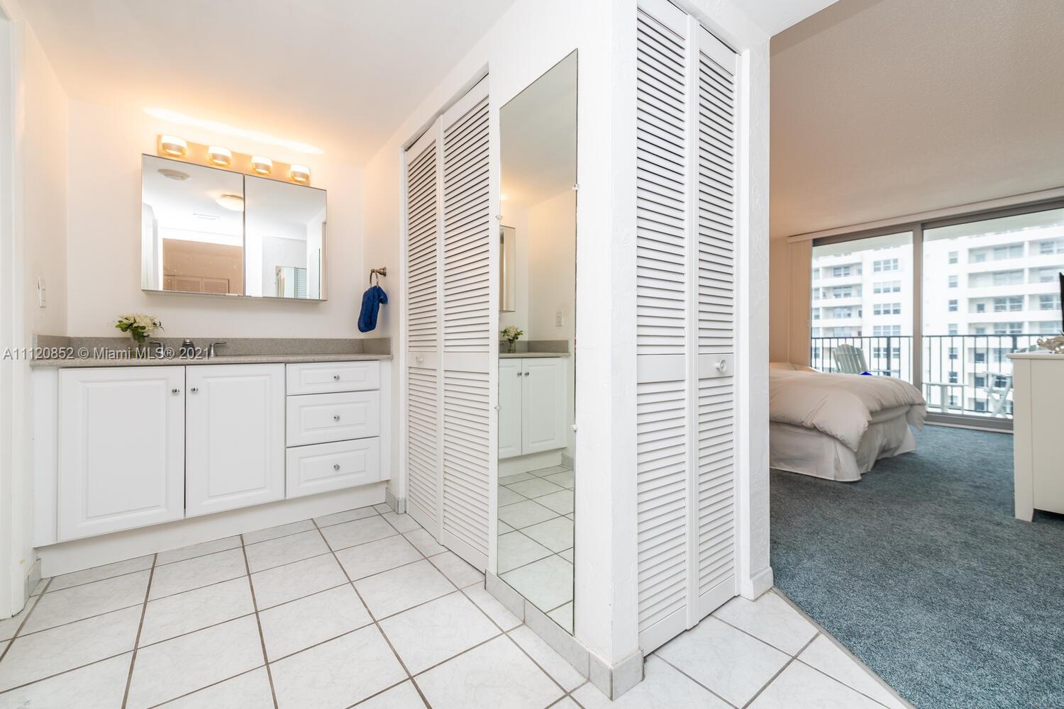 9273 Collins Avenue, Unit 801 Surfside, FL 33154 - Photo 22 of 47 a spacious bathroom with a shower and a sink