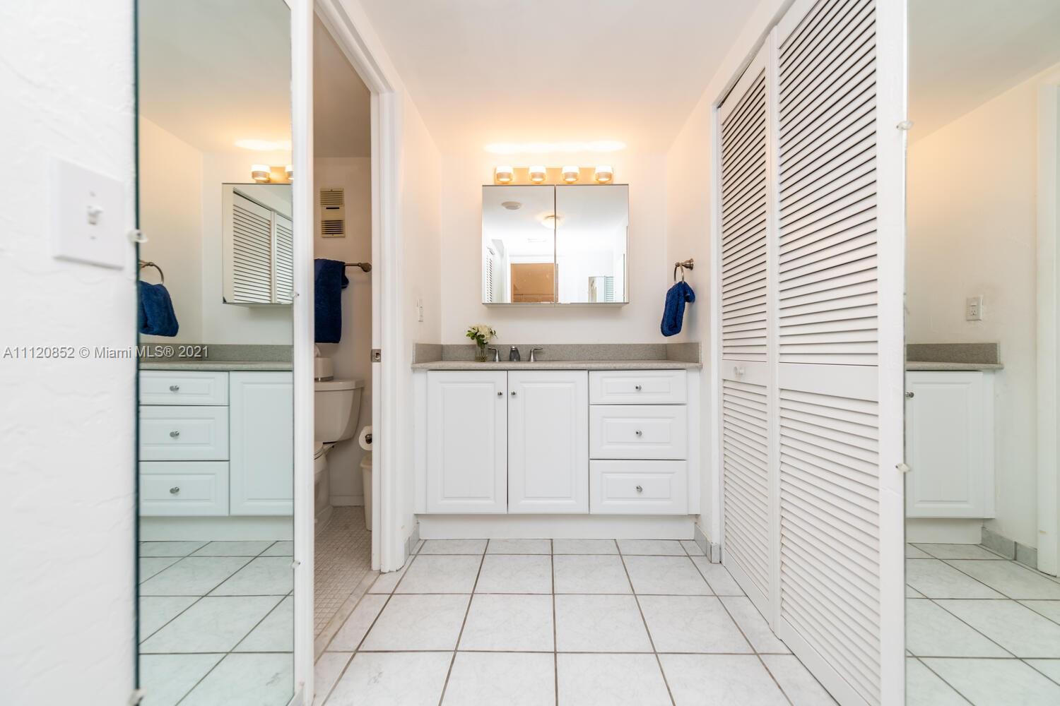 9273 Collins Avenue, Unit 801 Surfside, FL 33154 - Photo 23 of 47 a bathroom with a sink and a mirror