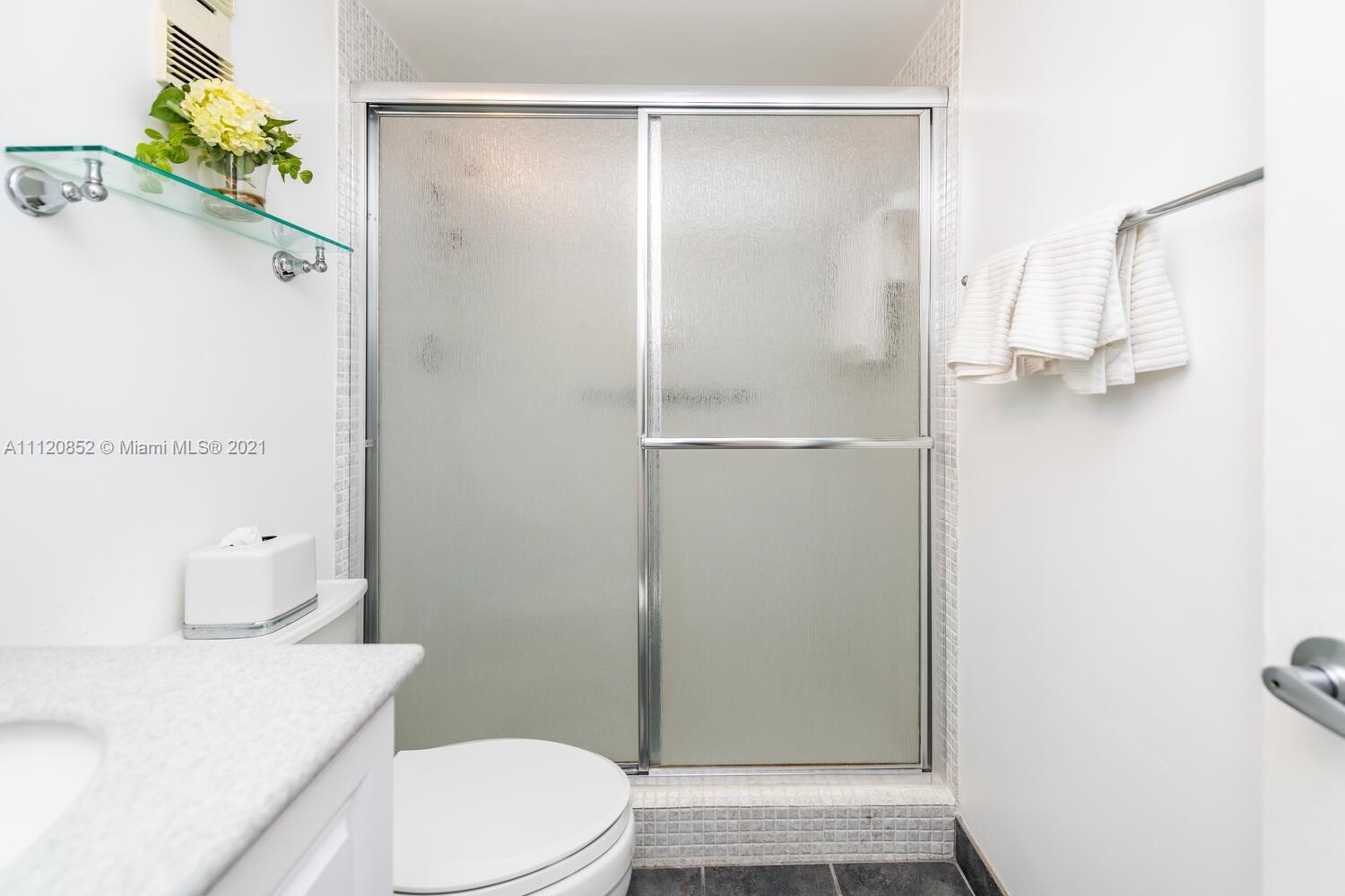 9273 Collins Avenue, Unit 801 Surfside, FL 33154 - Photo 3 of 47 a bathroom with a sink a toilet and shower