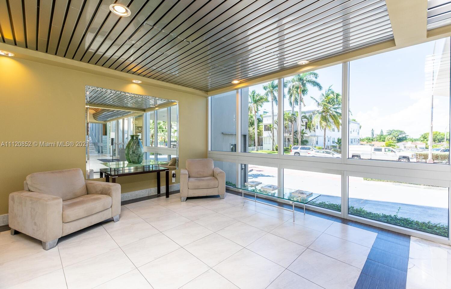 9273 Collins Avenue, Unit 801 Surfside, FL 33154 - Photo 33 of 47 a living room with couch and a large window