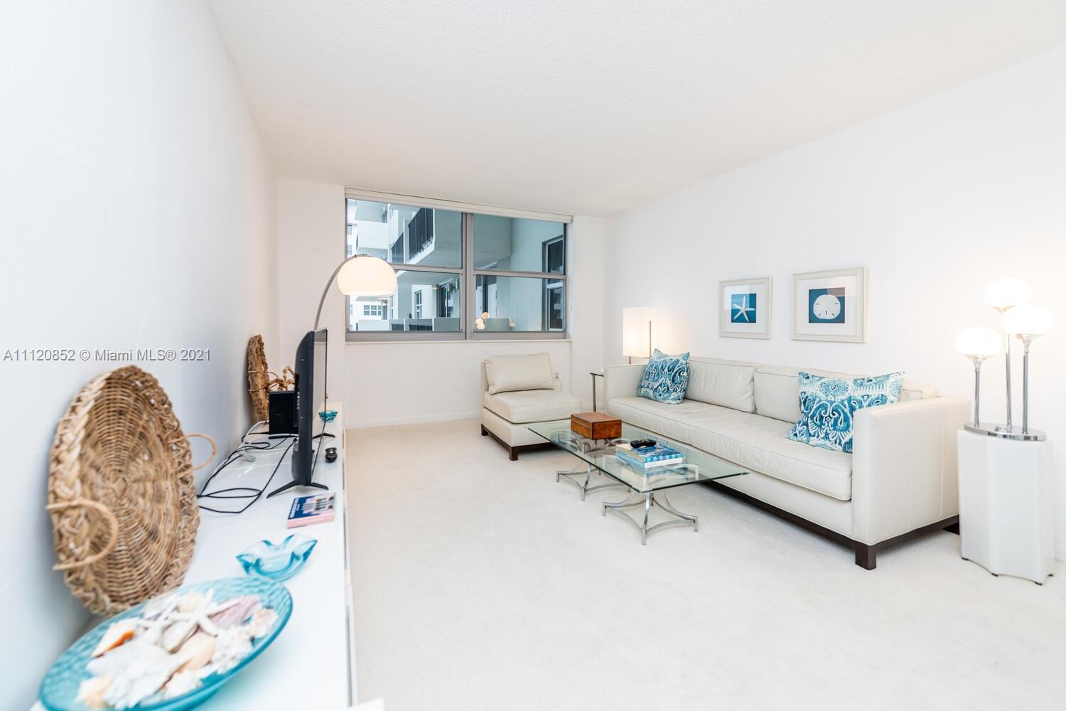 9273 Collins Avenue, Unit 801 Surfside, FL 33154 - Photo 8 of 47 a living room with furniture and wooden floor
