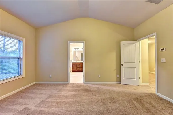 an empty room with windows and closet
