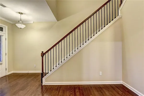 a view of staircase with wooden floor and fan
