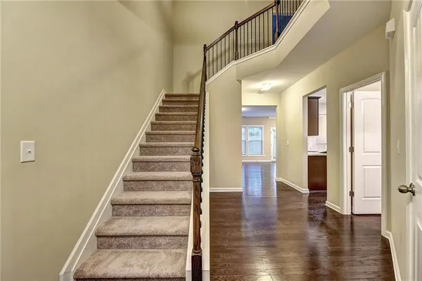 a view of an entryway with wooden floor and stairs