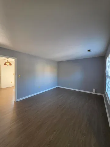 a view of an empty room and wooden floor