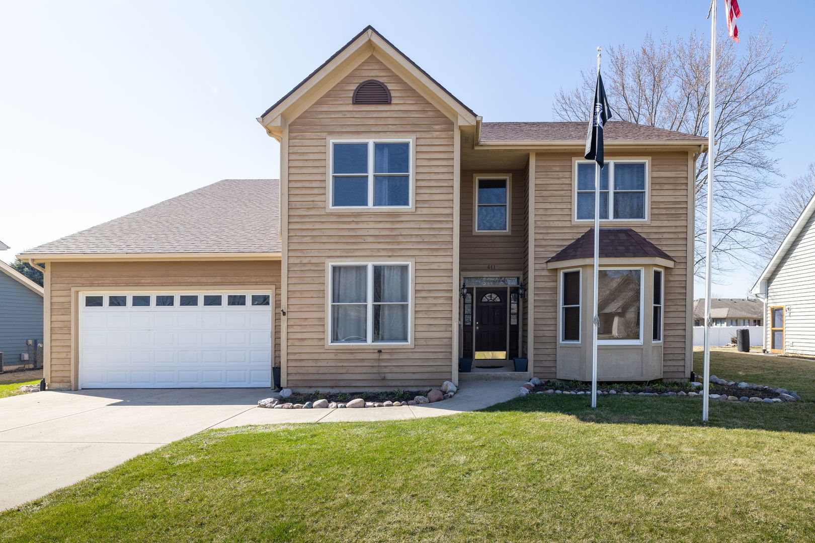 611 Prairie View Lane Hinckley, IL 60520 - Photo 1 of 40 a front view of a house with a yard and garage