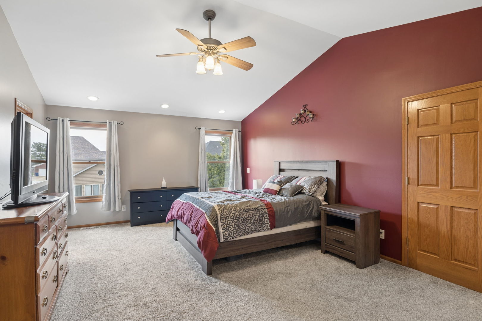 611 Prairie View Lane Hinckley, IL 60520 - Photo 20 of 40 a spacious bedroom with a bed dresser and a flat tv screen
