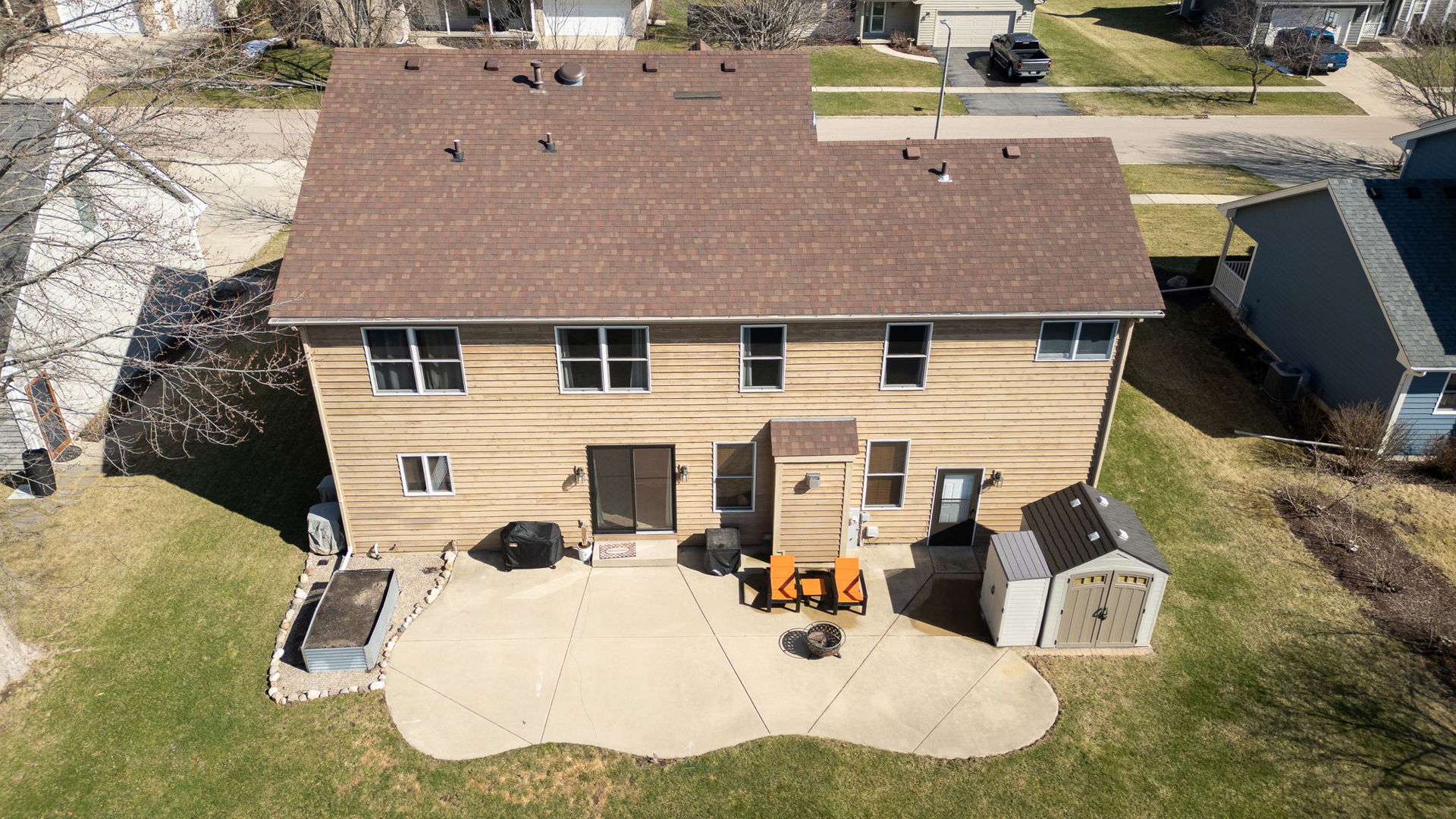 611 Prairie View Lane Hinckley, IL 60520 - Photo 33 of 40 a backyard of a house with large trees and outdoor seating