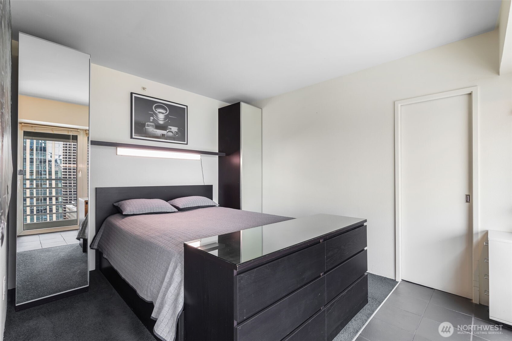 1415 2nd Avenue, Unit 2108 Seattle, WA 98101 - Photo 12 of 27 a bedroom with a bed and a window