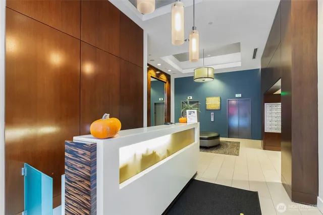 a kitchen with a sink a counter top space and living room view