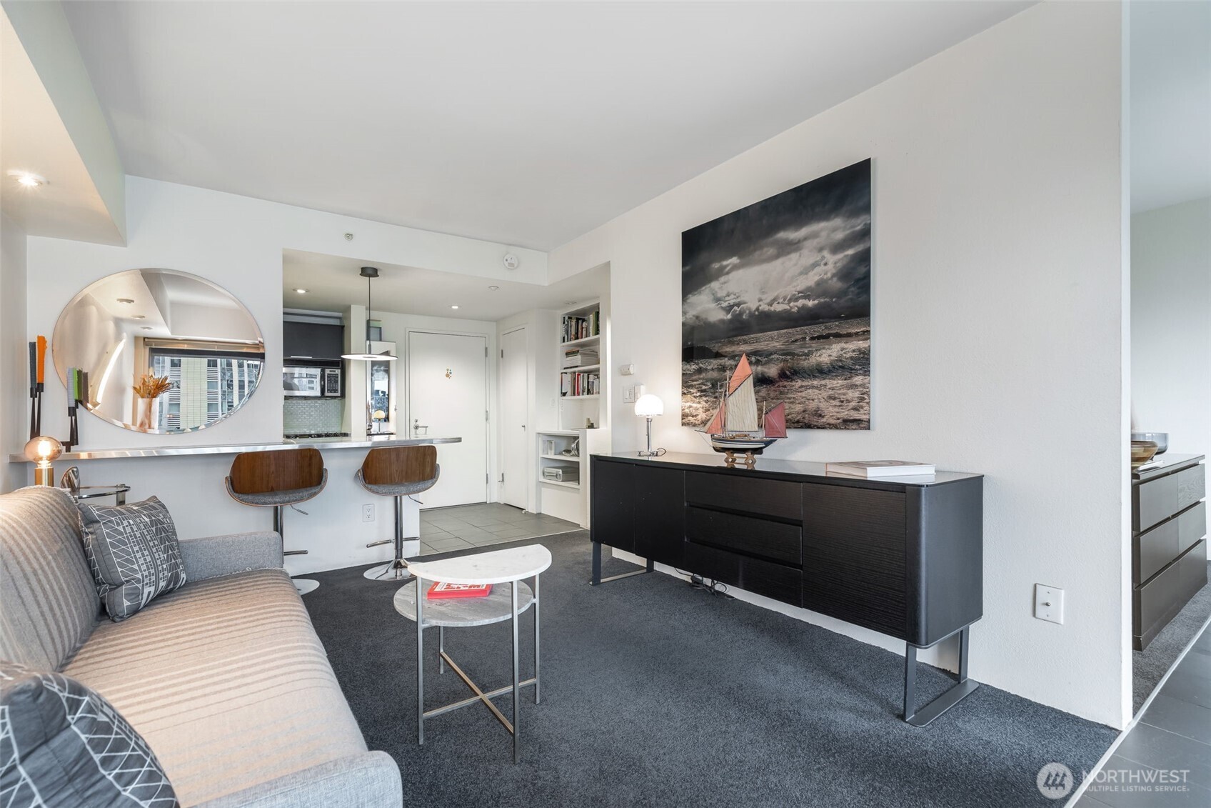 1415 2nd Avenue, Unit 2108 Seattle, WA 98101 - Photo 7 of 27 a living room with furniture and paintings on the wall