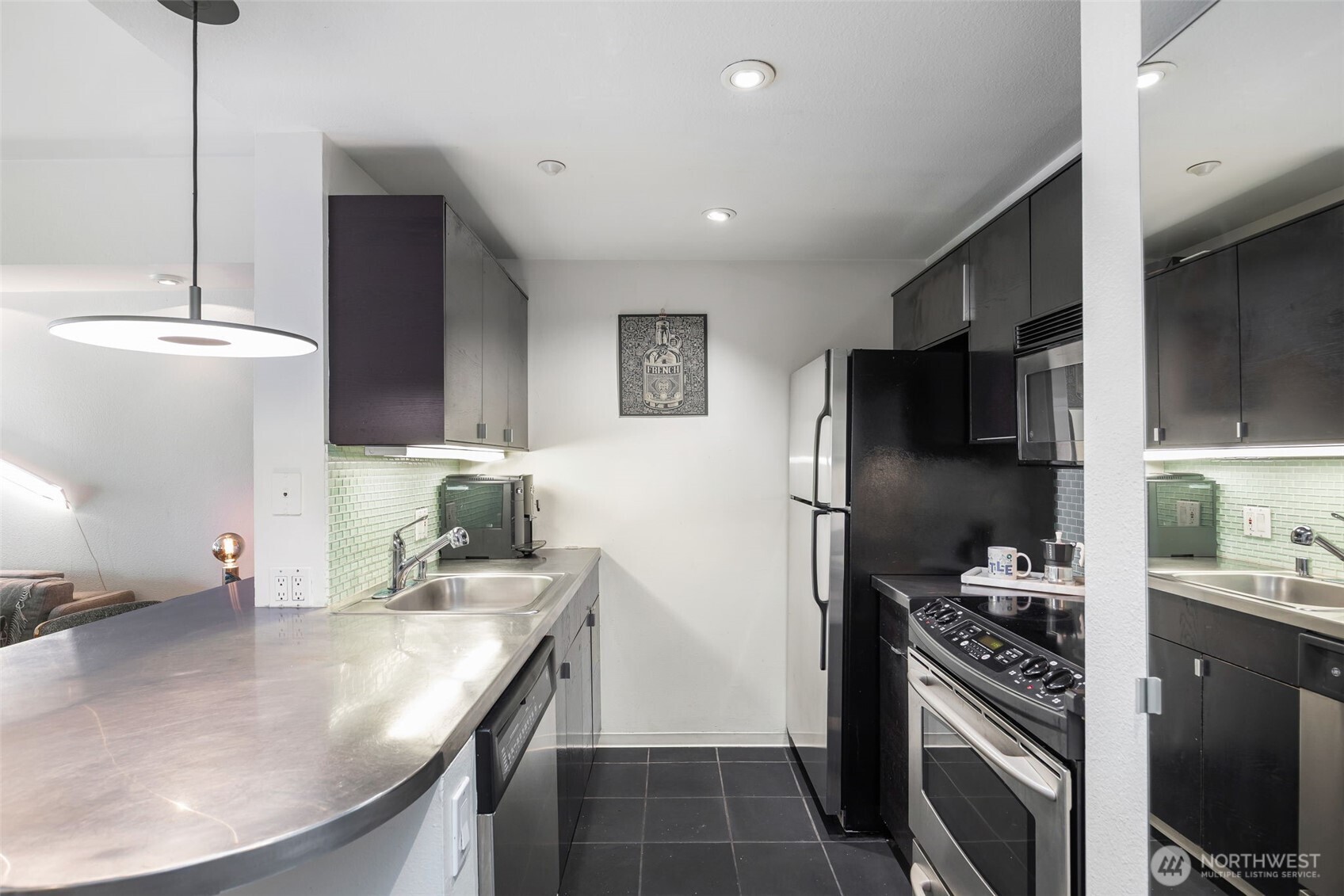 1415 2nd Avenue, Unit 2108 Seattle, WA 98101 - Photo 9 of 27 a kitchen with stainless steel appliances granite countertop a sink stove and refrigerator