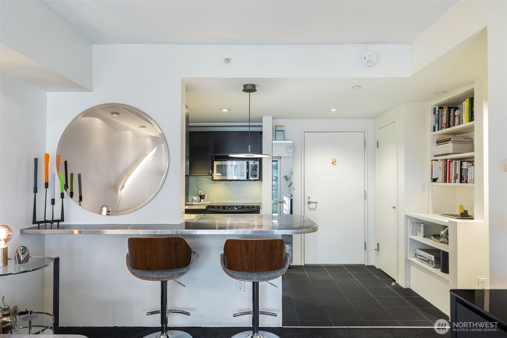1415 2nd Avenue, Unit 2108 Seattle, WA 98101 - Photo 9 of 27 a kitchen with cabinets and chairs