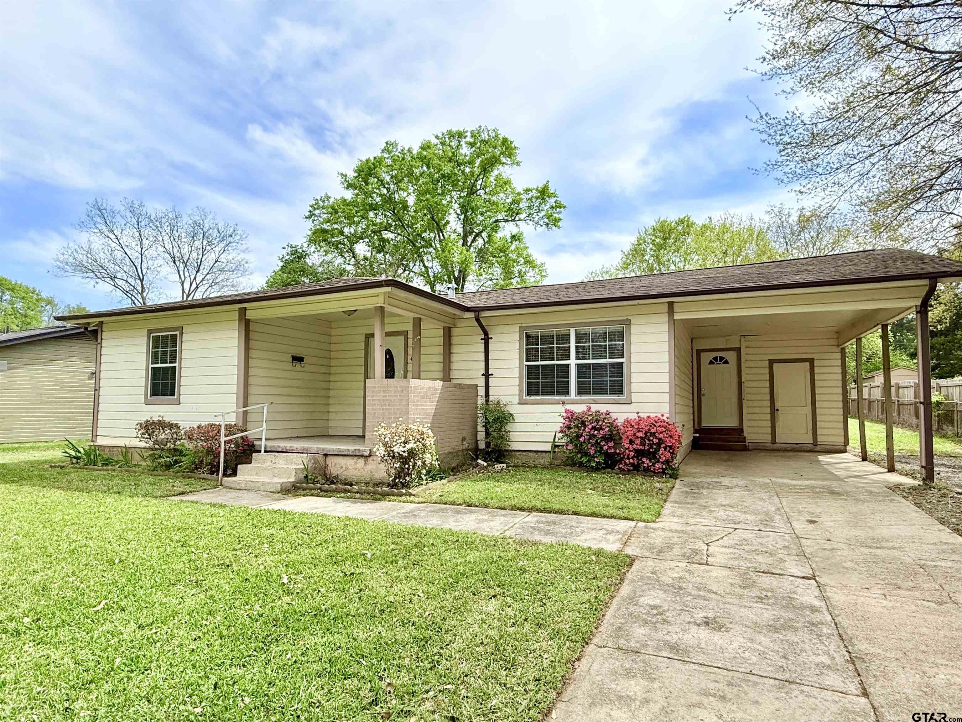 404 Beckley Street Kilgore, TX 75662 - Photo 1 of 20 a front view of a house with yard and green space
