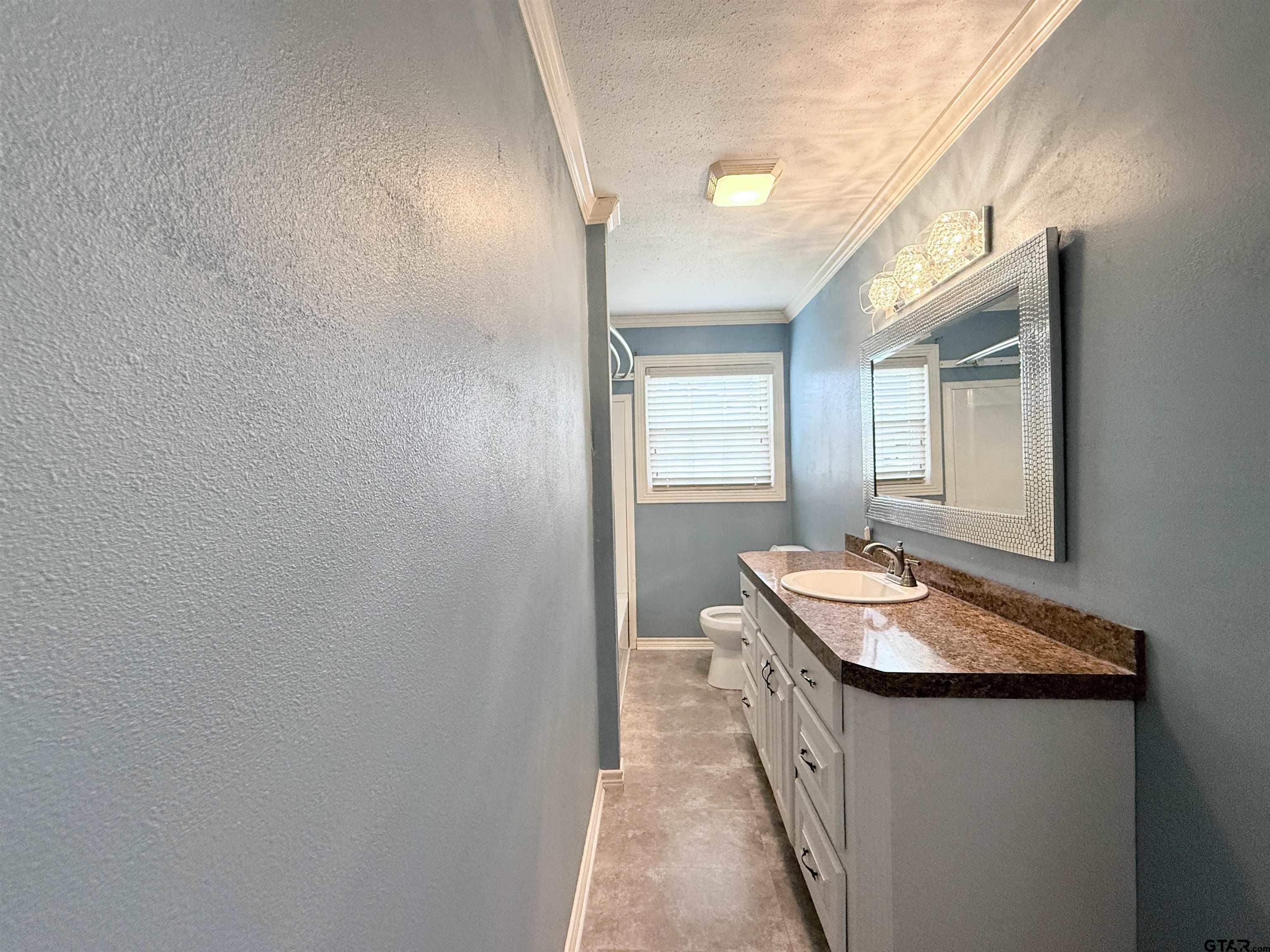 404 Beckley Street Kilgore, TX 75662 - Photo 12 of 20 a bathroom with sink and mirror