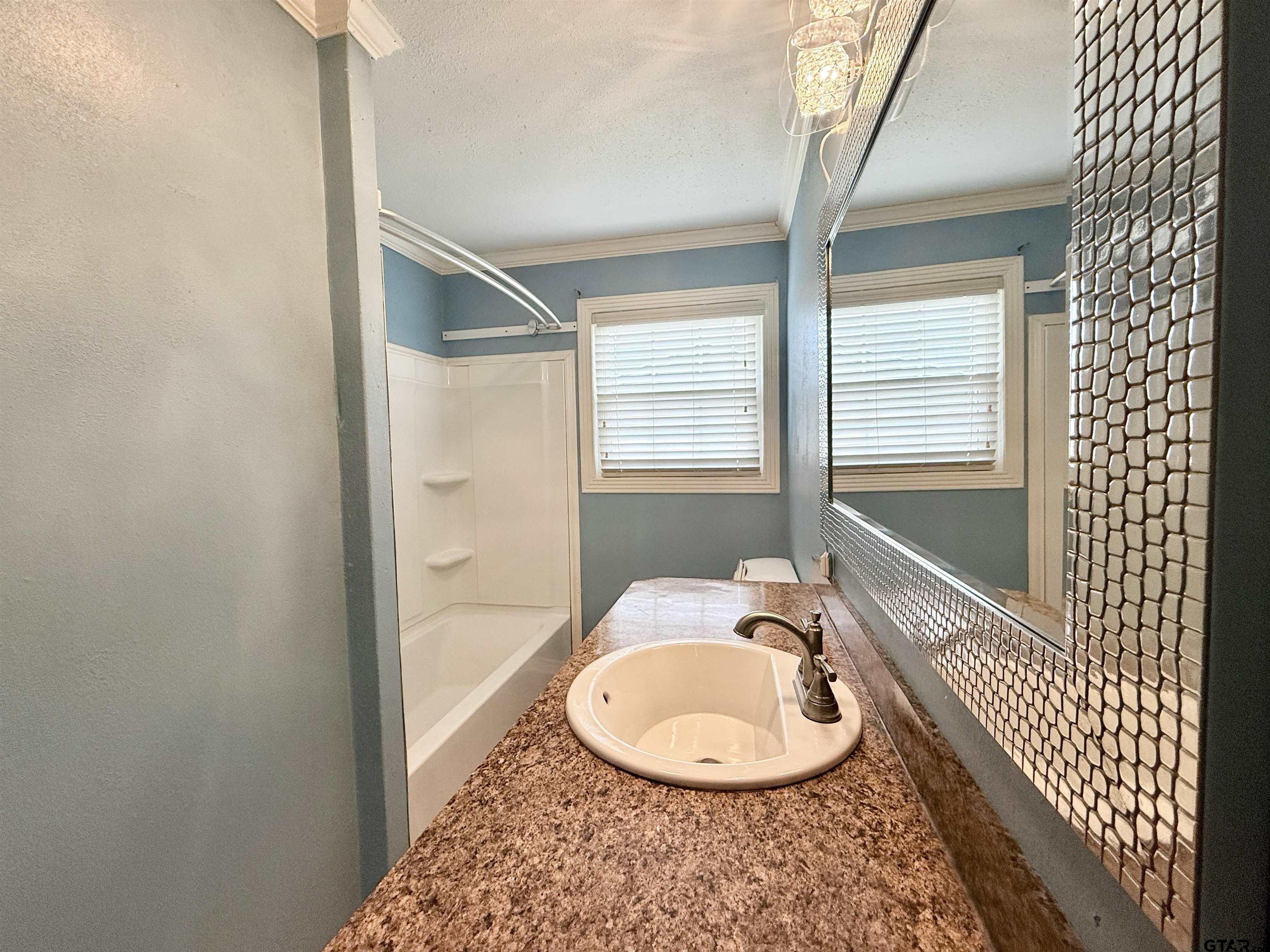 404 Beckley Street Kilgore, TX 75662 - Photo 13 of 20 a bathroom with a sink a toilet and shower
