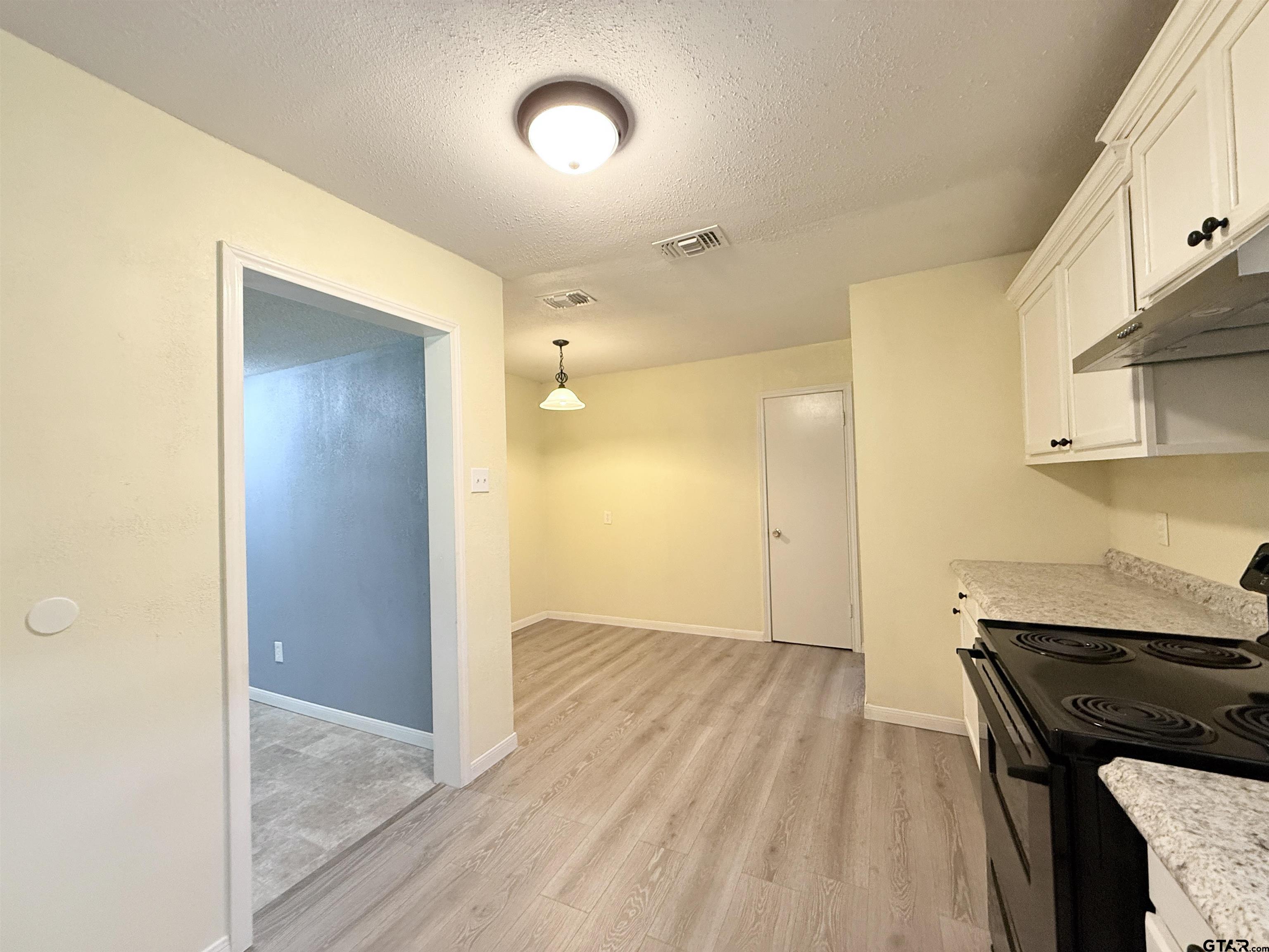 404 Beckley Street Kilgore, TX 75662 - Photo 7 of 20 a view of a kitchen from the hallway