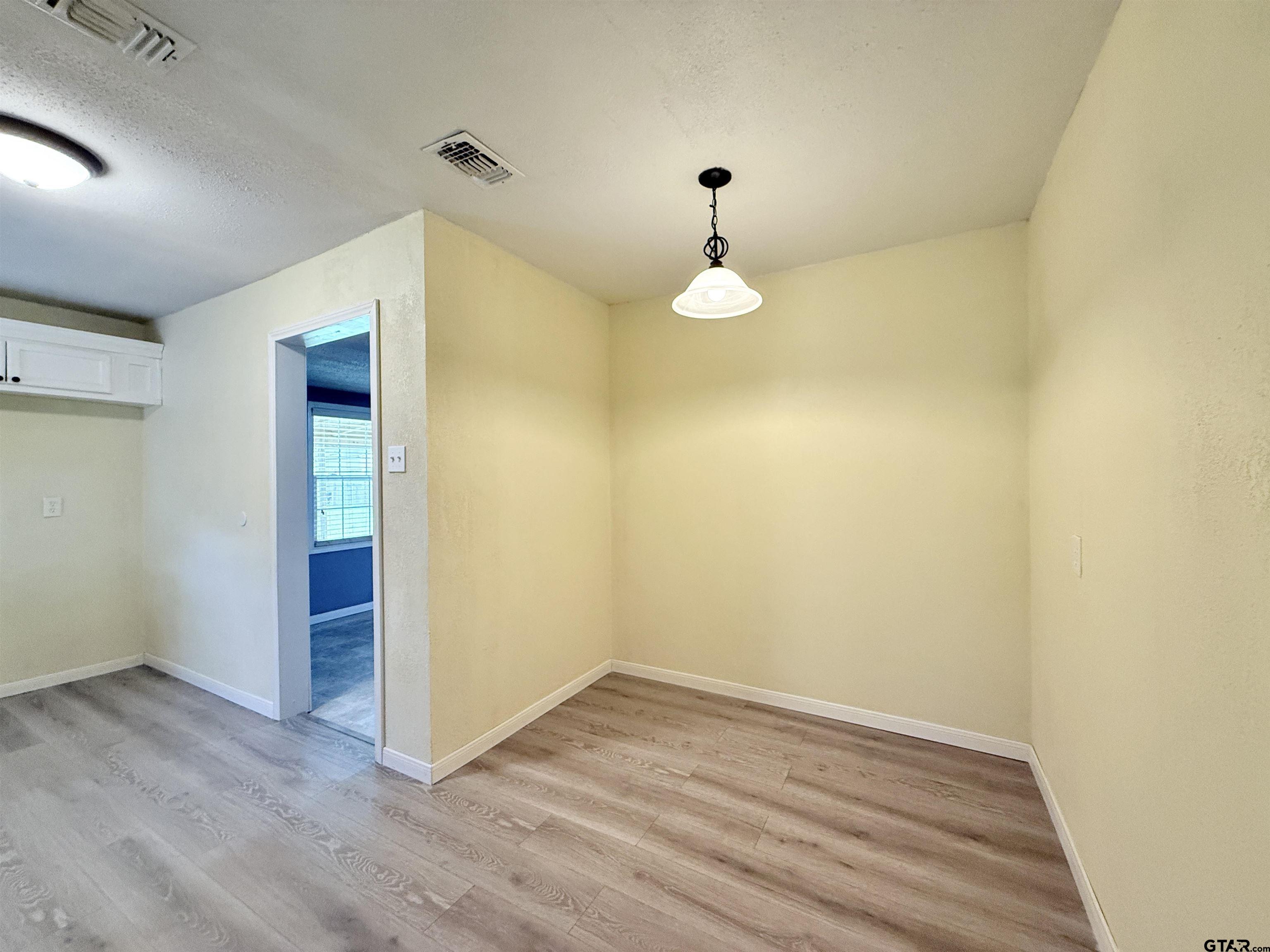 404 Beckley Street Kilgore, TX 75662 - Photo 8 of 20 a view of empty room with wooden floor