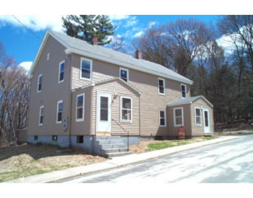 21-23 Anderson Street Three Rivers, MA 01080 - Photo 1 of 1 a front view of a house with a yard