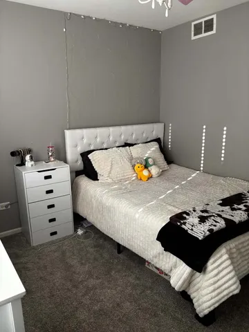 a bedroom with a bed and lamp