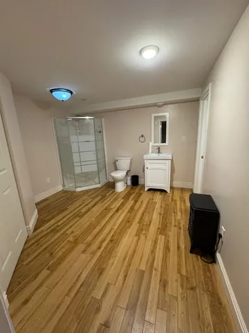 a living room with a couch and a wooden floor