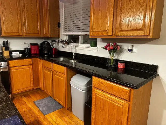 a kitchen with stainless steel appliances granite countertop a sink stove and cabinets