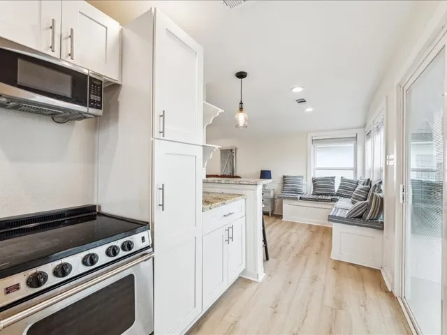 an empty room with furniture and flat screen tv