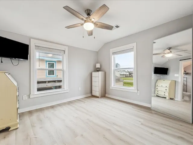 a bathroom with a granite countertop sink toilet a mirror and shower