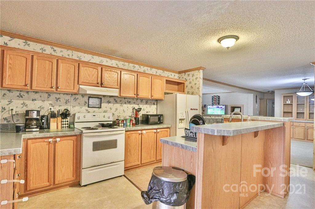 117 Valley Springs Road Olin, NC 28660 - Photo 12 of 38 a kitchen with stainless steel appliances granite countertop a stove and a refrigerator
