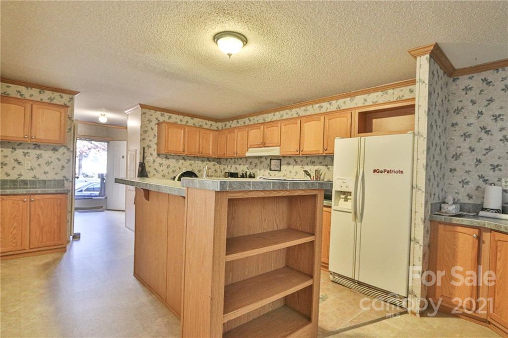 117 Valley Springs Road Olin, NC 28660 - Photo 13 of 38 a view of kitchen with stainless steel appliances granite countertop a refrigerator and a stove top oven