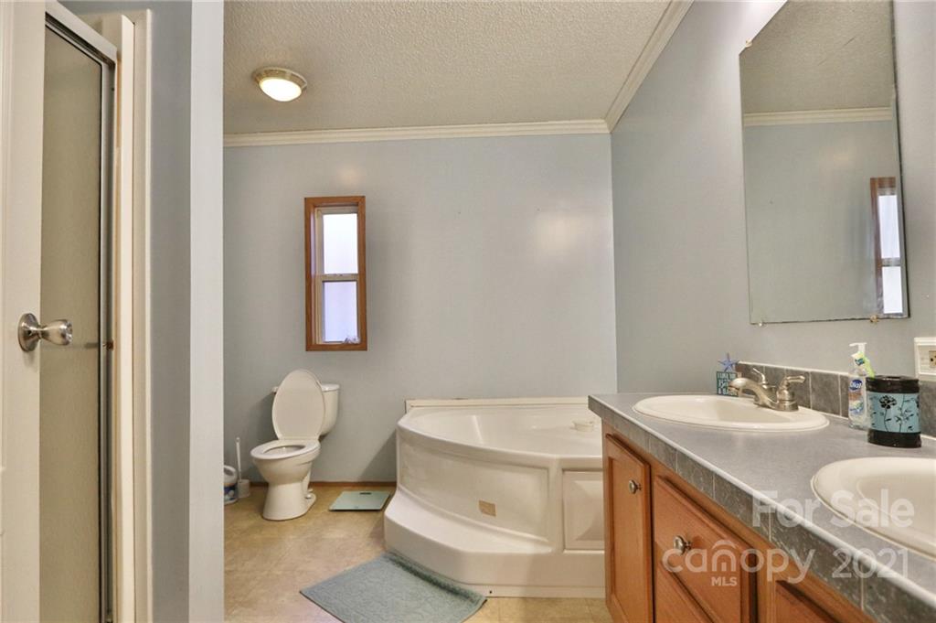 117 Valley Springs Road Olin, NC 28660 - Photo 22 of 38 a bathroom with a sink toilet and vanity