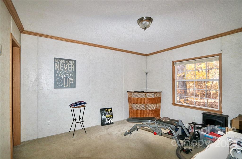 117 Valley Springs Road Olin, NC 28660 - Photo 26 of 38 a room with furniture and a window