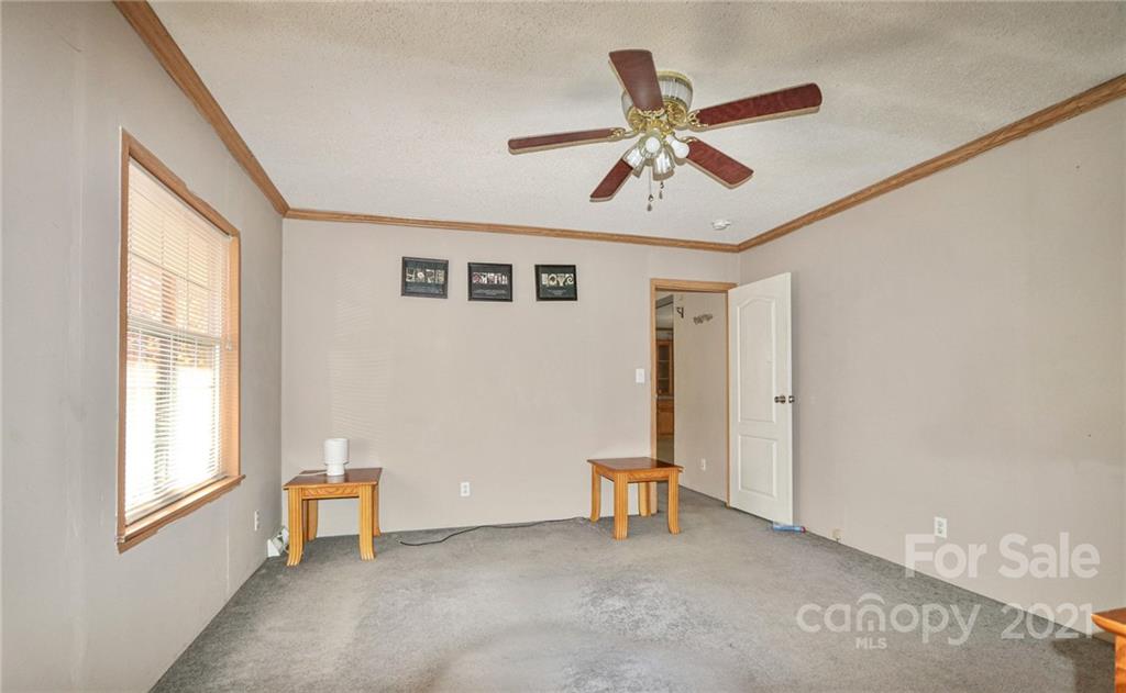 117 Valley Springs Road Olin, NC 28660 - Photo 29 of 38 a view of a livingroom with a ceiling fan and window