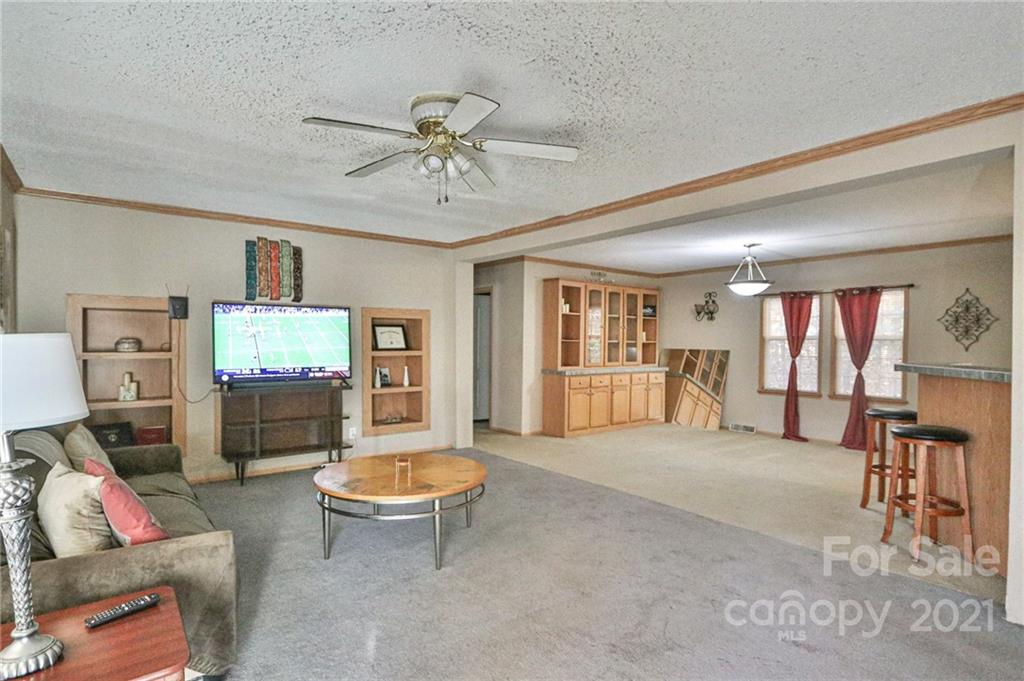 117 Valley Springs Road Olin, NC 28660 - Photo 4 of 38 a living room with furniture and a flat screen tv