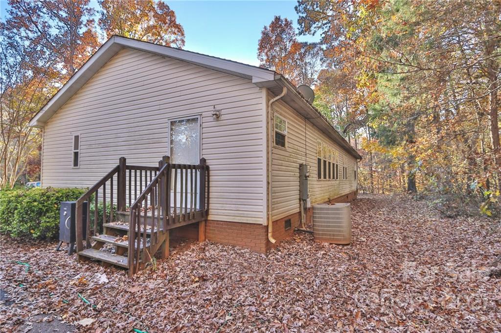 117 Valley Springs Road Olin, NC 28660 - Photo 36 of 38 a view of a house with a yard and wooden fence