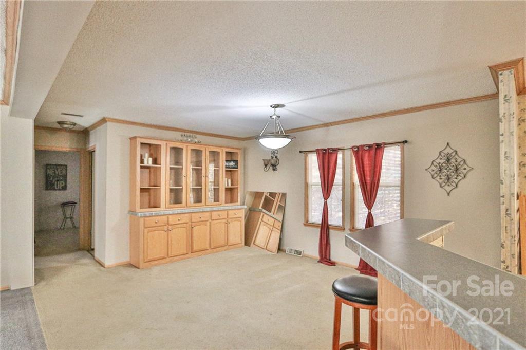 117 Valley Springs Road Olin, NC 28660 - Photo 6 of 38 a room with gym equipment and large window