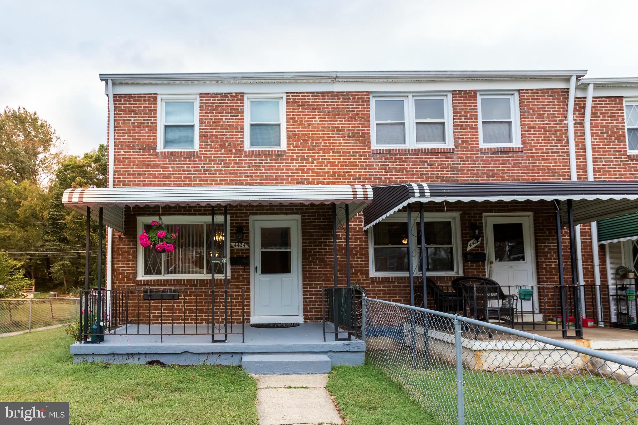 4424 Scotia Road Baltimore, MD 21227 - Photo 2 of 26 a view of brick building with a large window and a yard