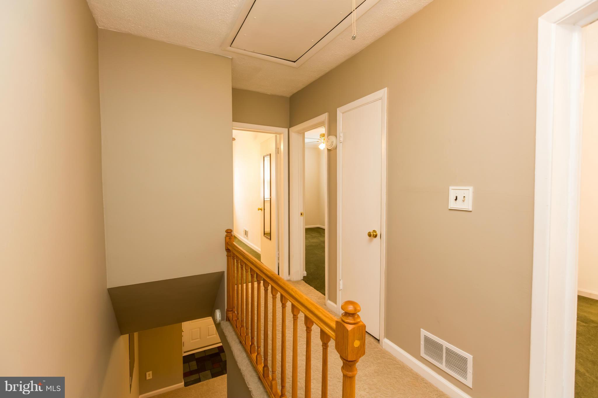 4424 Scotia Road Baltimore, MD 21227 - Photo 13 of 26 a view of a hallway with wooden floor and staircase