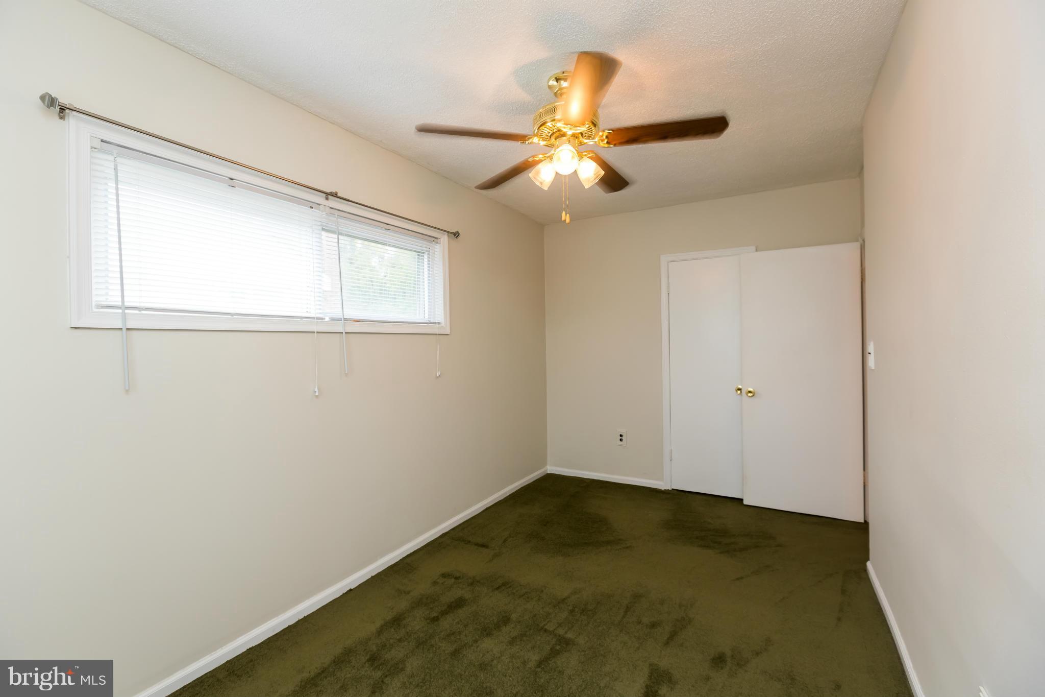 4424 Scotia Road Baltimore, MD 21227 - Photo 18 of 26 an empty room with windows and fan