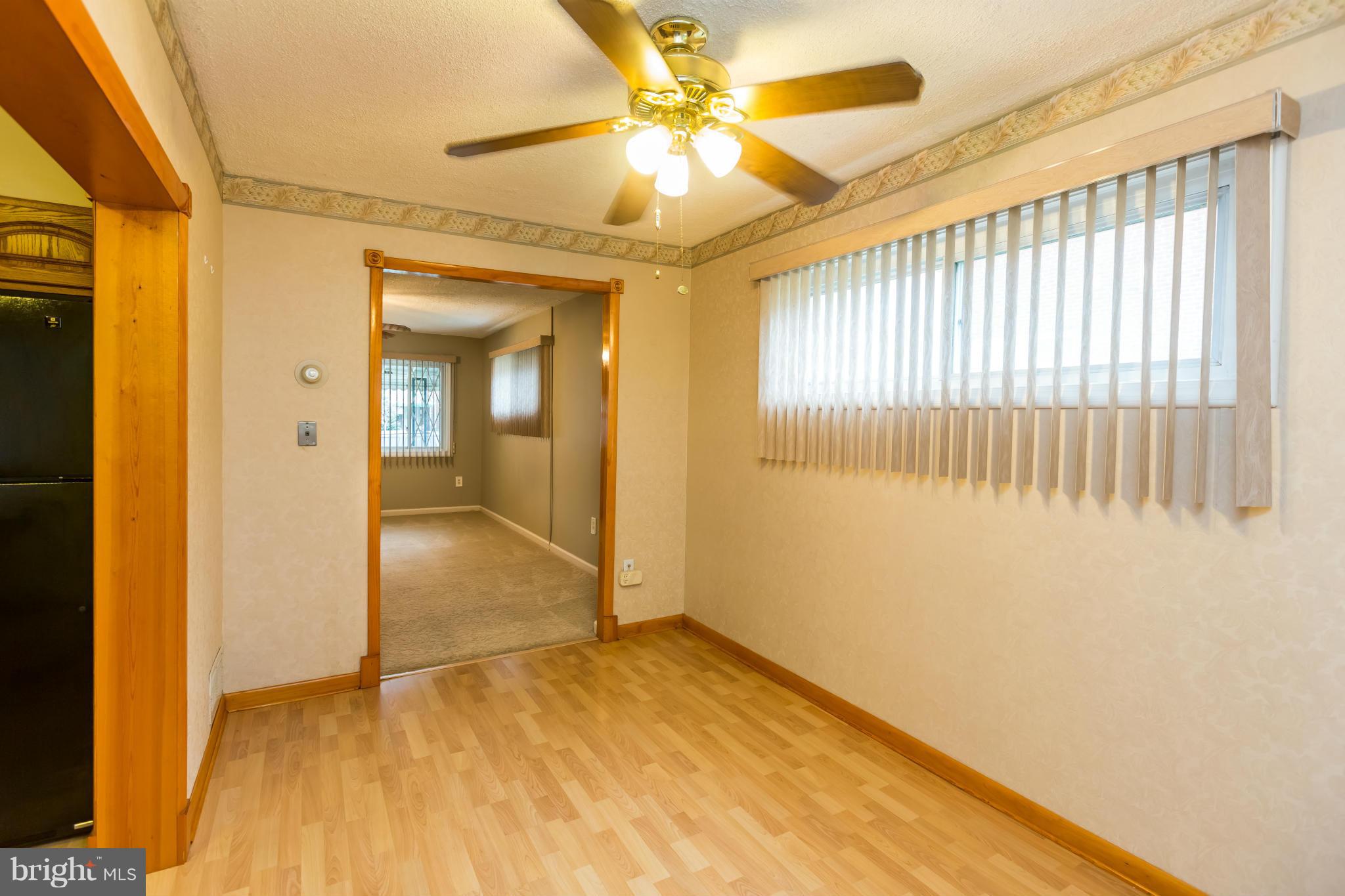 4424 Scotia Road Baltimore, MD 21227 - Photo 6 of 26 a view of livingroom with hardwood floor and a ceiling fan