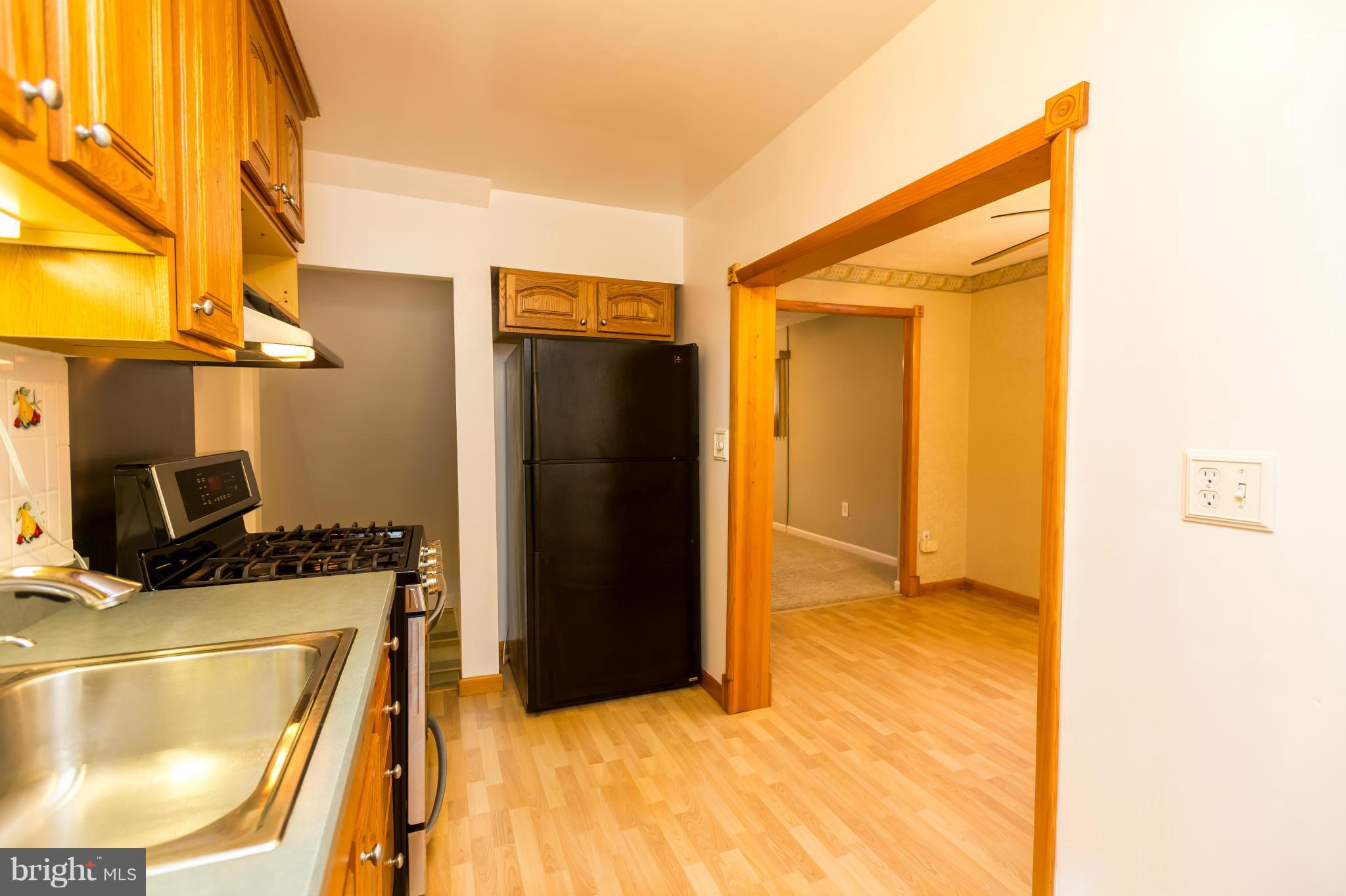 4424 Scotia Road Baltimore, MD 21227 - Photo 9 of 26 a kitchen with a refrigerator and a stove