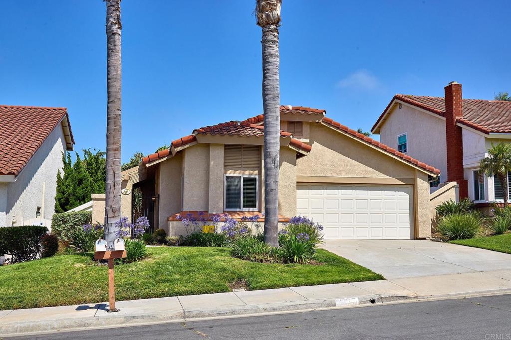 a front view of house with small garden on both side