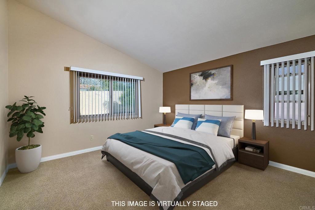 932 Alyssum Road Carlsbad, CA 92011 - Photo 12 of 31 a bedroom with a bed and a potted plant