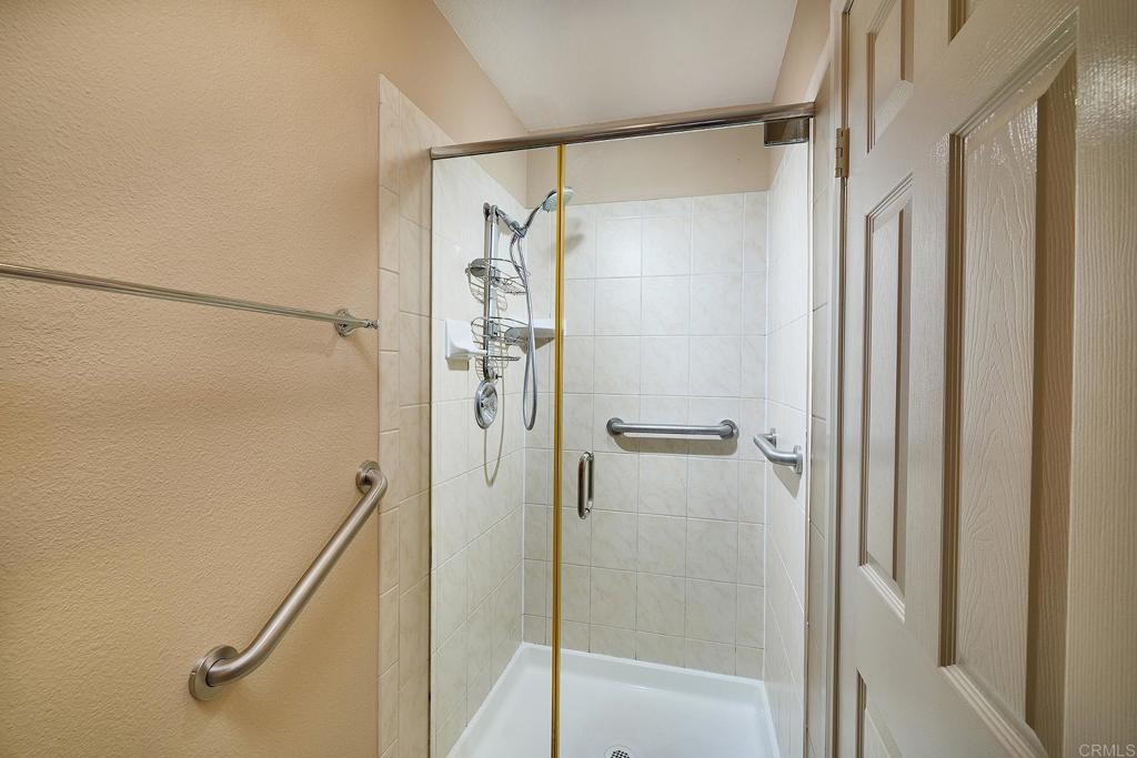 932 Alyssum Road Carlsbad, CA 92011 - Photo 14 of 31 a bathroom with a glass shower door
