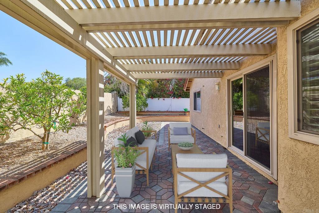 932 Alyssum Road Carlsbad, CA 92011 - Photo 18 of 31 a porch with a table and chairs and potted plants