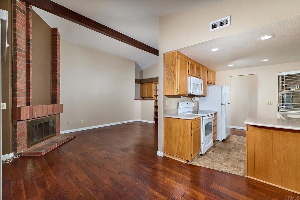 932 Alyssum Road Carlsbad, CA 92011 - Photo 4 of 31 a kitchen with stainless steel appliances granite countertop a refrigerator a stove top oven and a sink