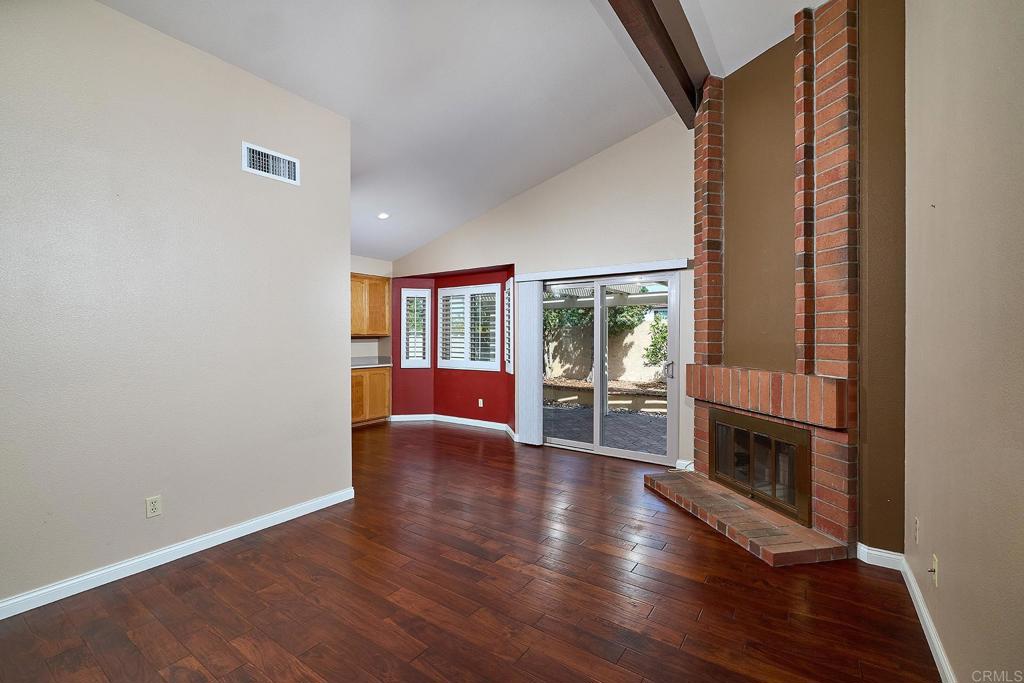 932 Alyssum Road Carlsbad, CA 92011 - Photo 6 of 31 wooden floor in an empty room with a fireplace