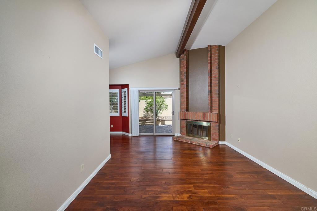 932 Alyssum Road Carlsbad, CA 92011 - Photo 7 of 31 a view of an empty room with wooden floor and a window