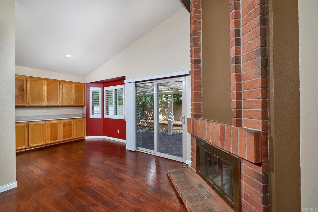 932 Alyssum Road Carlsbad, CA 92011 - Photo 8 of 31 a view of an empty room with wooden floor and a window